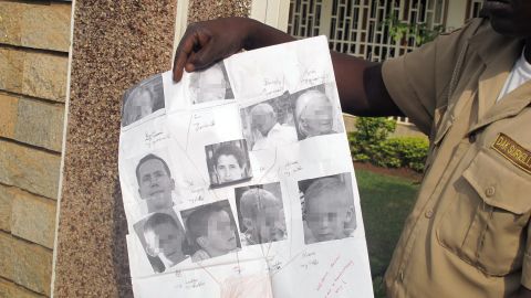 February 21, 2013: Security guard shows photos of the French family kidnapped on February 19. 