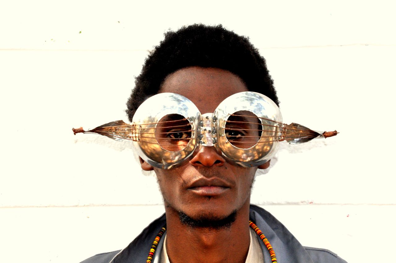 Cyrus Kabiru is a Kenyan sculptor and painter creating artworks from found objects.