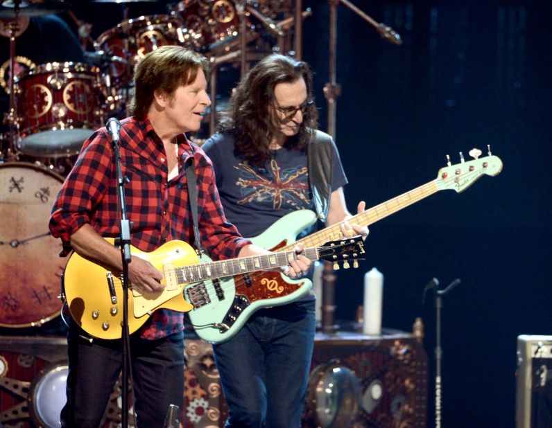 John Fogerty, left, and Rush's Geddy Lee perform together.