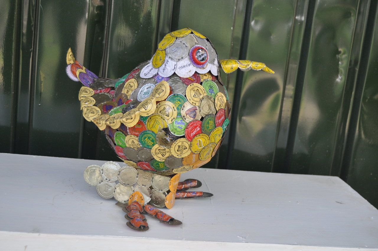 Apart from his arresting spectacles, Kabiru is also crafting sculptures from trash he collects. This piece is made from bottle tops. 