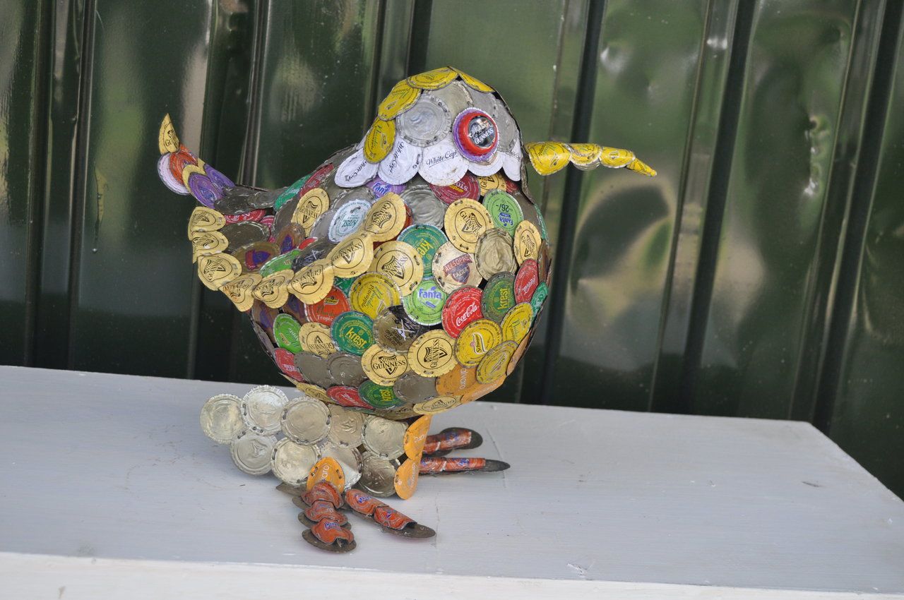Apart from his arresting spectacles, Kabiru is also crafting sculptures from trash he collects. This piece is made from bottle tops.