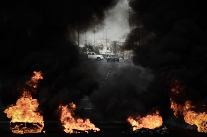 Tires placed on the road by anti-regime protestors burn during clashes with riot police in the village of Diraz, west of Manama. Bahrain riot police fired tear gas and stun grenades at protesters, who hurled petrol bombs during protests against the staging of the race.