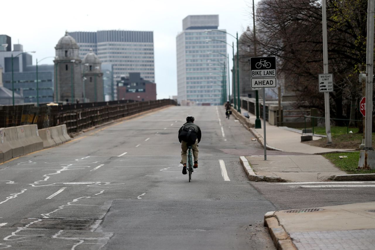 A lone bicyclist makes his way across the Longfellow Bridge.