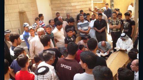 Mourners give their condolences to family members of the victims who were killed in the explosion in Al- Amirya.