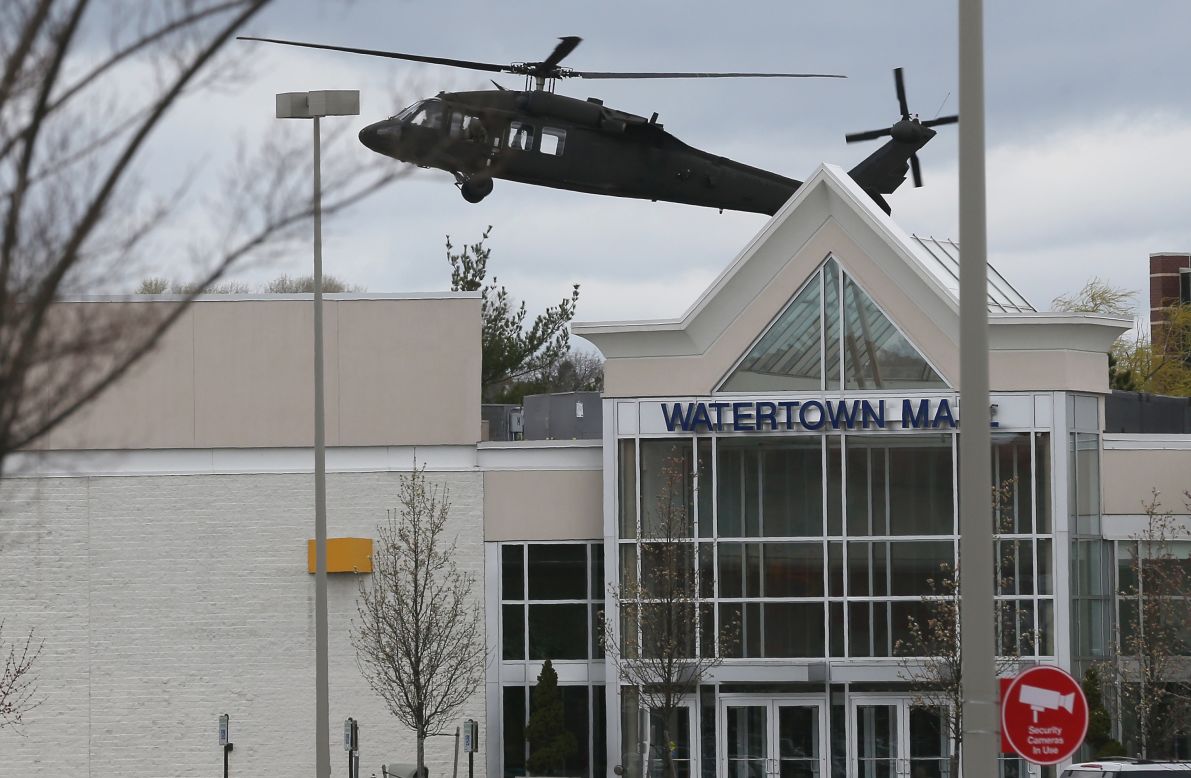 A U.S. military helicopter lands behind Watertown Mall as law enforcement agencies continue to search for the 19-year-old bombing suspect on Friday.
