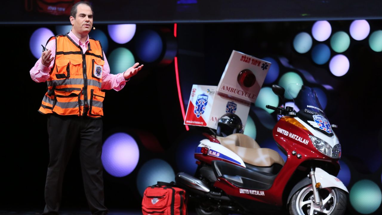 Israeli medic Eli Beer speaks at TEDMED alongside his "ambu-cycle." Beer founded an all-volunteer rescue service.