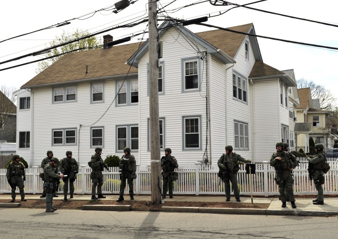 SWAT team members line a residential street in Watertown, Massachusetts, as the manhunt continues on Friday.