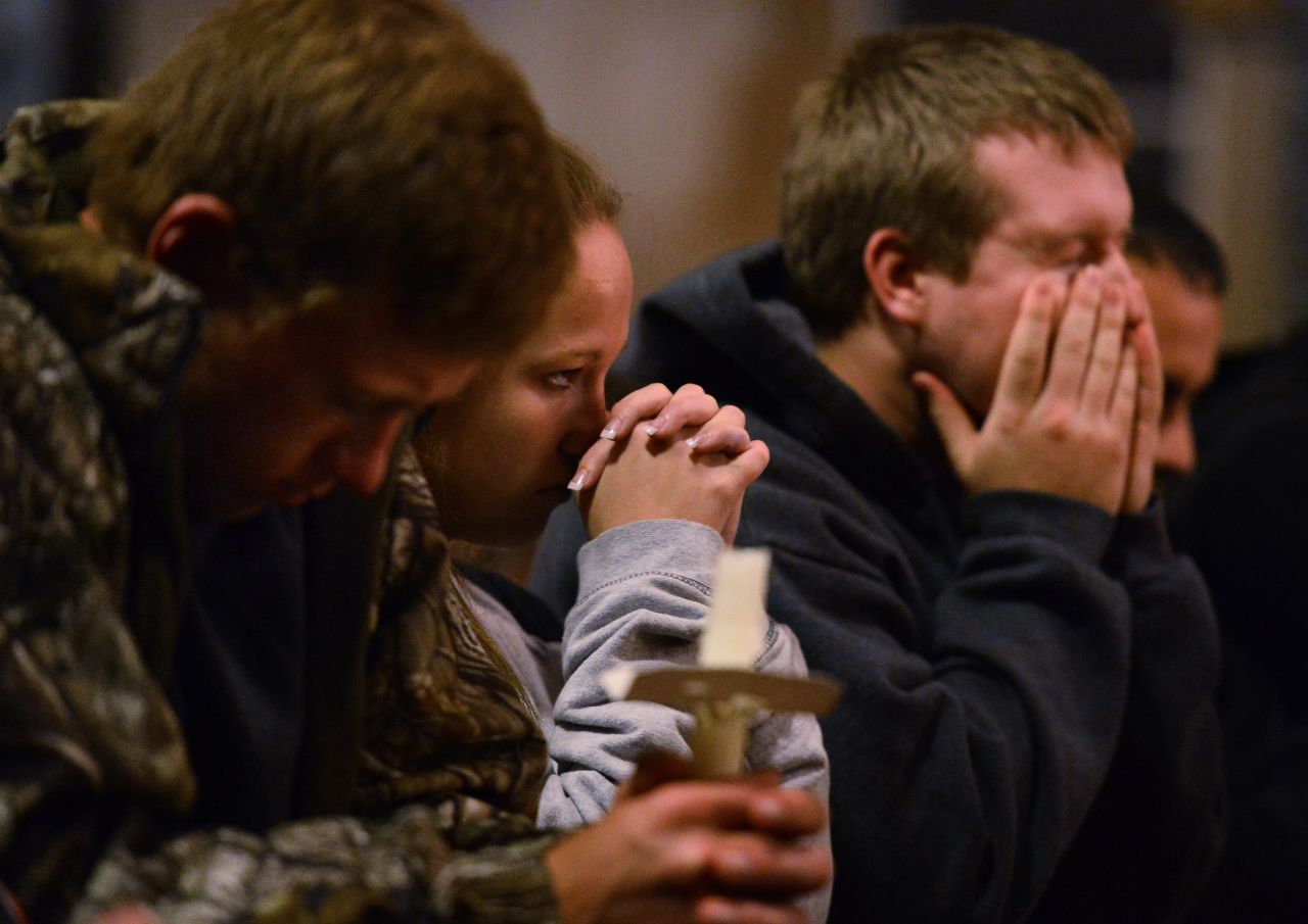 People pray during a candlelight vigil at St. Mary's Church on April 18.