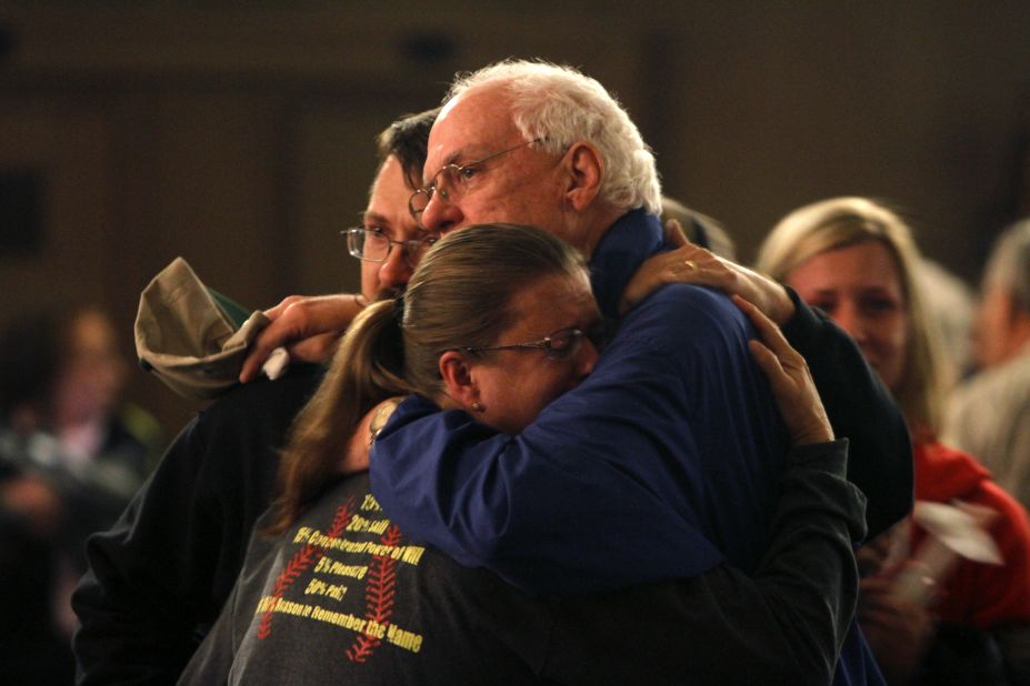 Residents embrace after taking part in the vigil.