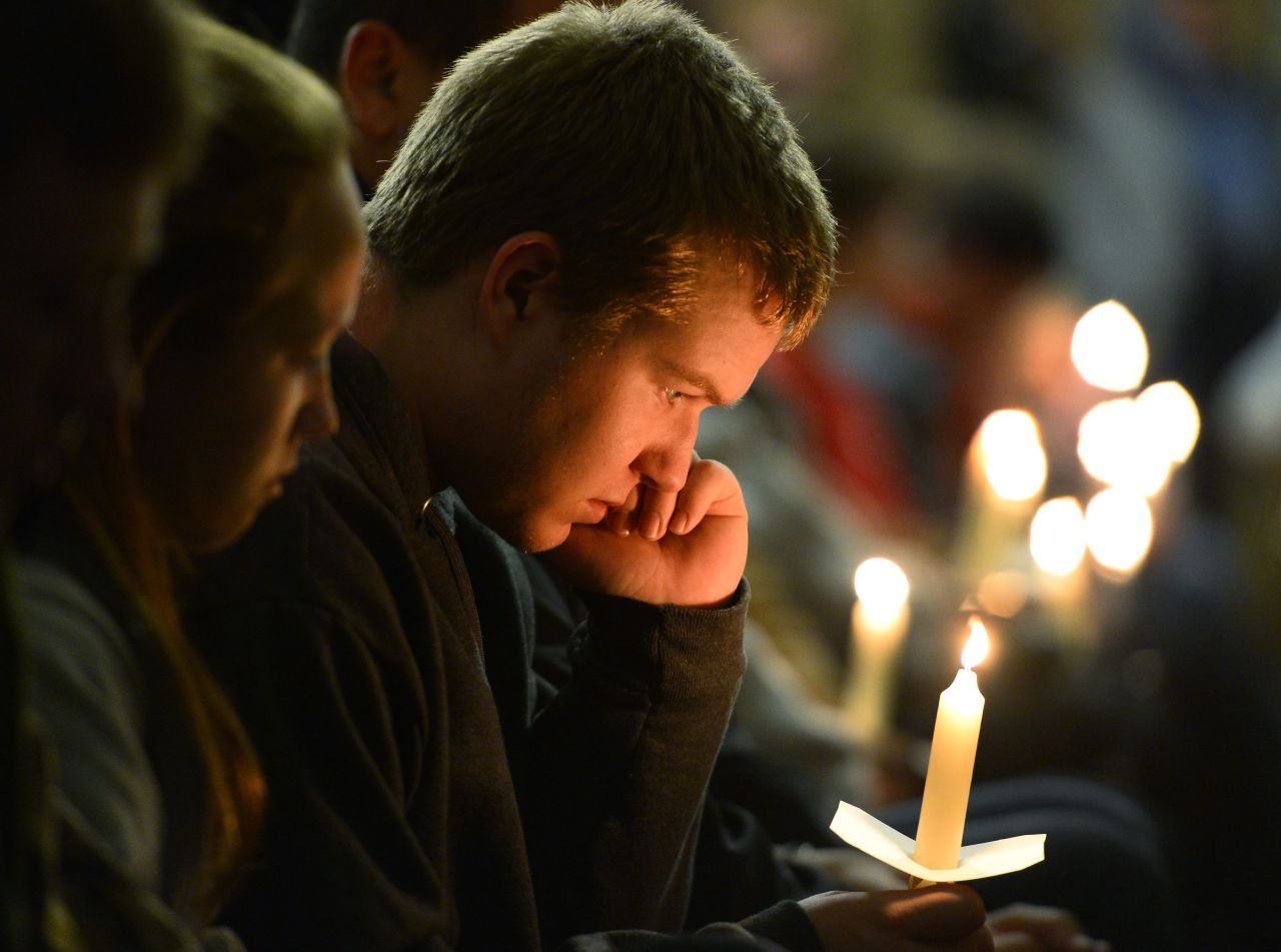 A young man holds a candle during the vigil.<a href="http://www.cnn.com/2013/04/18/us/gallery/texas-explosion/index.html"> </a>