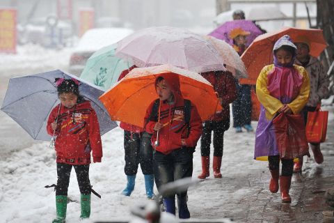 Children still feel the bite of winter weather in Taiyuan, the capital of north China's Shanxi Province, on April 19.