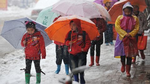 Children still feel the bite of winter weather in Taiyuan, the capital of north China's Shanxi Province, on April 19.