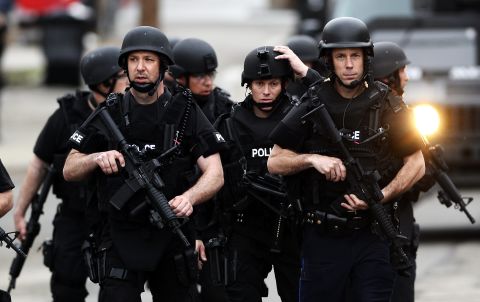 SWAT team members move down residential streets as they perform door-to-door searches in Watertown, Massachusetts, on April 19. 