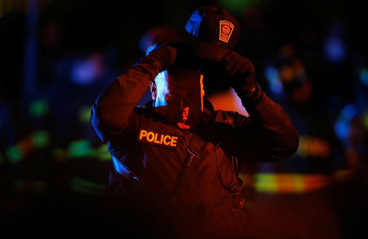 A police officer adjusts his hat while various law enforcement agencies descend on the area around Franklin Street on April 19.