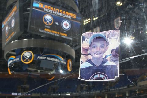 A photograph of Martin Richard, one of the victims of the Boston Marathon bombing, was placed on the plexiglass by a fan following the hockey game between the Buffalo Sabres and the New York Rangers on April 19 at the First Niagara Center in Buffalo, New York. 