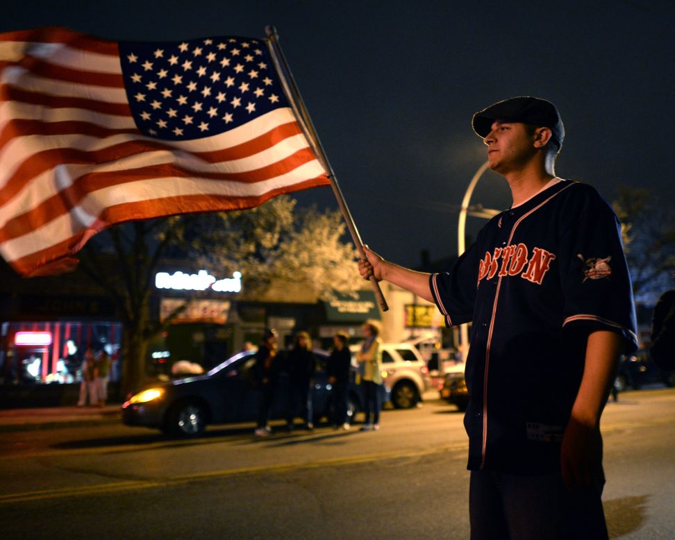 A man waves a U.S. flag in Watertown on April 19. 