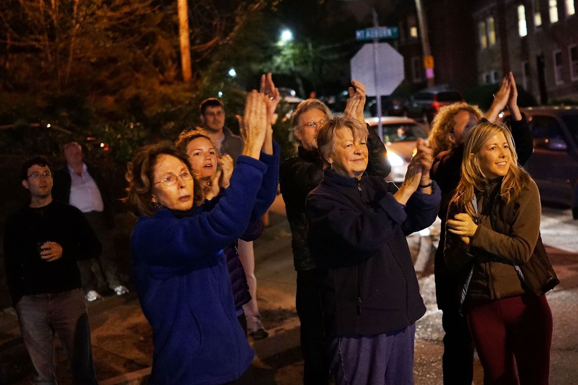 Women cheer police as they exit Franklin Street on Friday, April 19, in Watertown, Massachusetts. 