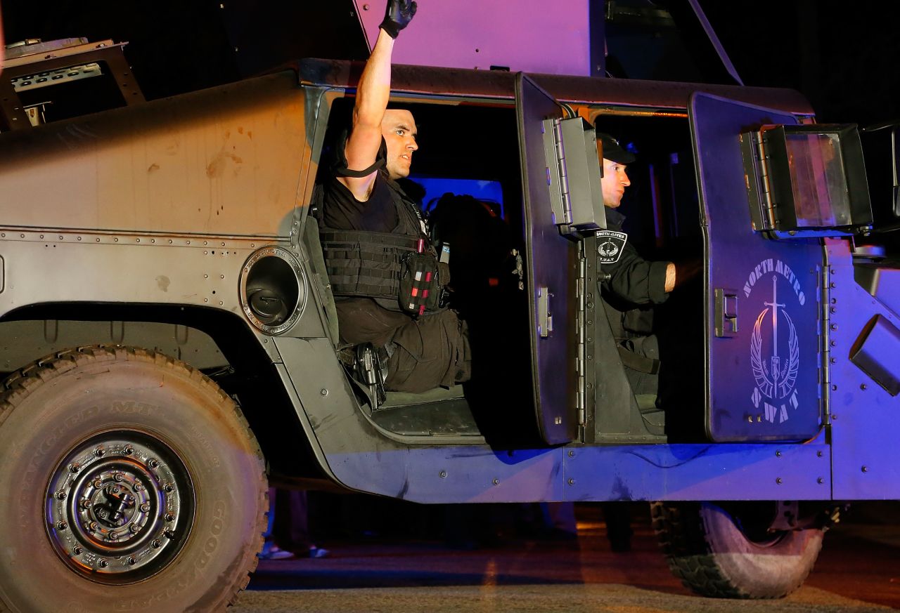 A member of the North Metro SWAT team pumps his fist while leaving the scene near Franklin Street on April 19.