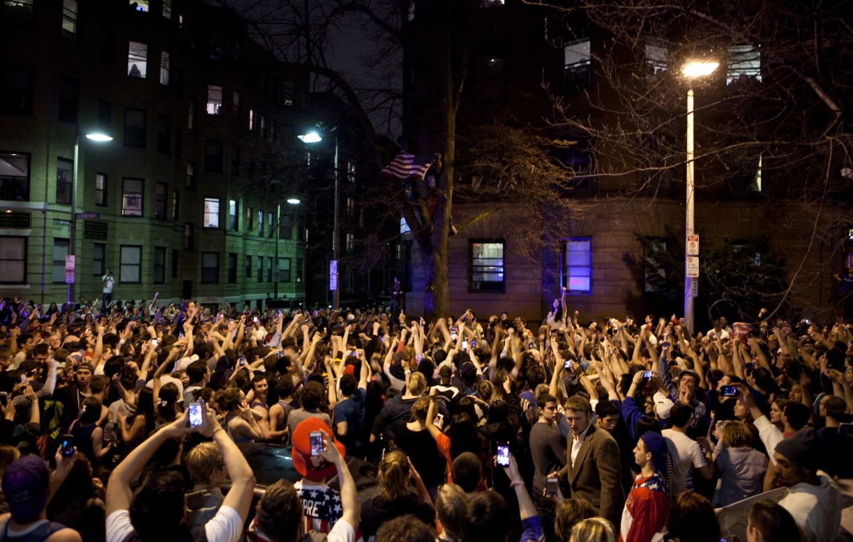 Around 200 people celebrate on Hemingway Street in the Fenway neighborhood after the capture of the second suspect on April 19.