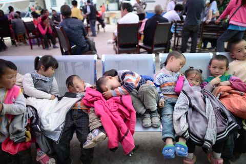 Displaced children rest at an evacuation shelter in Baosheng township on Saturday.