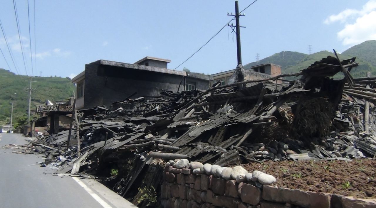 Houses collapsed on the side of a road in Sichuan province.