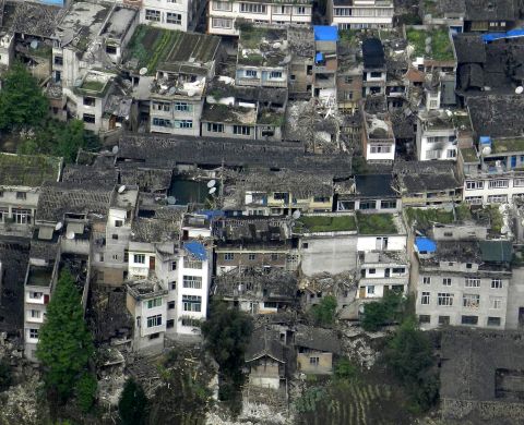 This photo taken on a helicopter shows the quake-destroyed houses in Taiping Town in Ya'an City on Saturday.