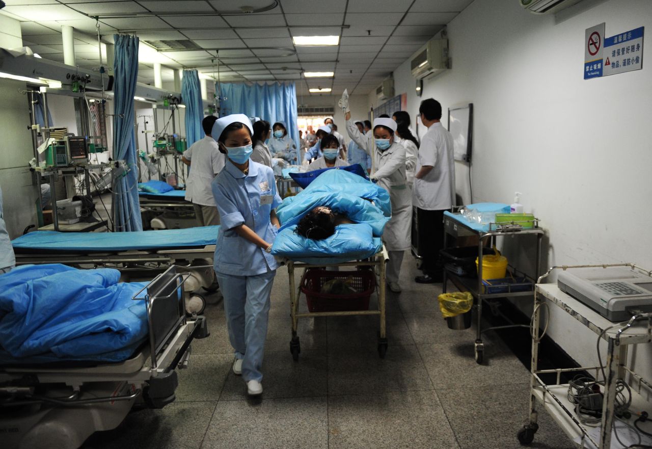 Medical workers pull an injured patient out of the emergency treatment room Saturday at a medical emergency center in Chengdu, the capital of Sichuan province.