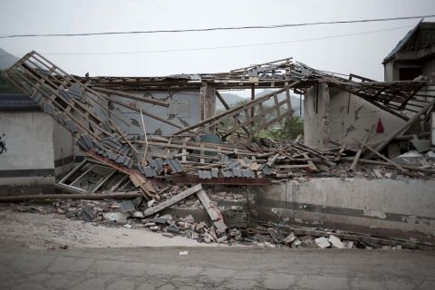 A collapsed house sits in Gucheng Village. 