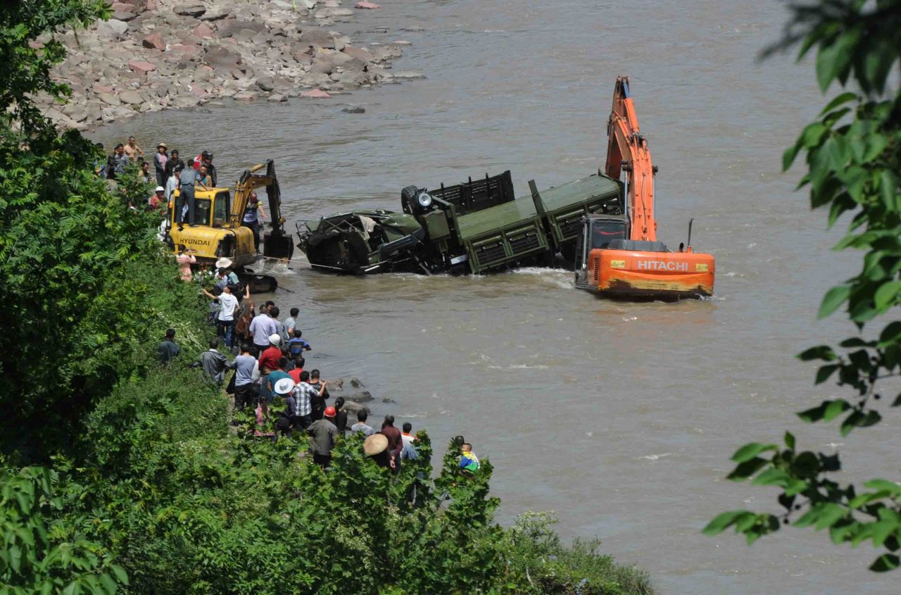A rescue car from Chengdu Military Region falls off a cliff into a river in Sichuan Province. Two of the 17 soldiers in the car had died by 11:30 p.m. Saturday Beijing time.
