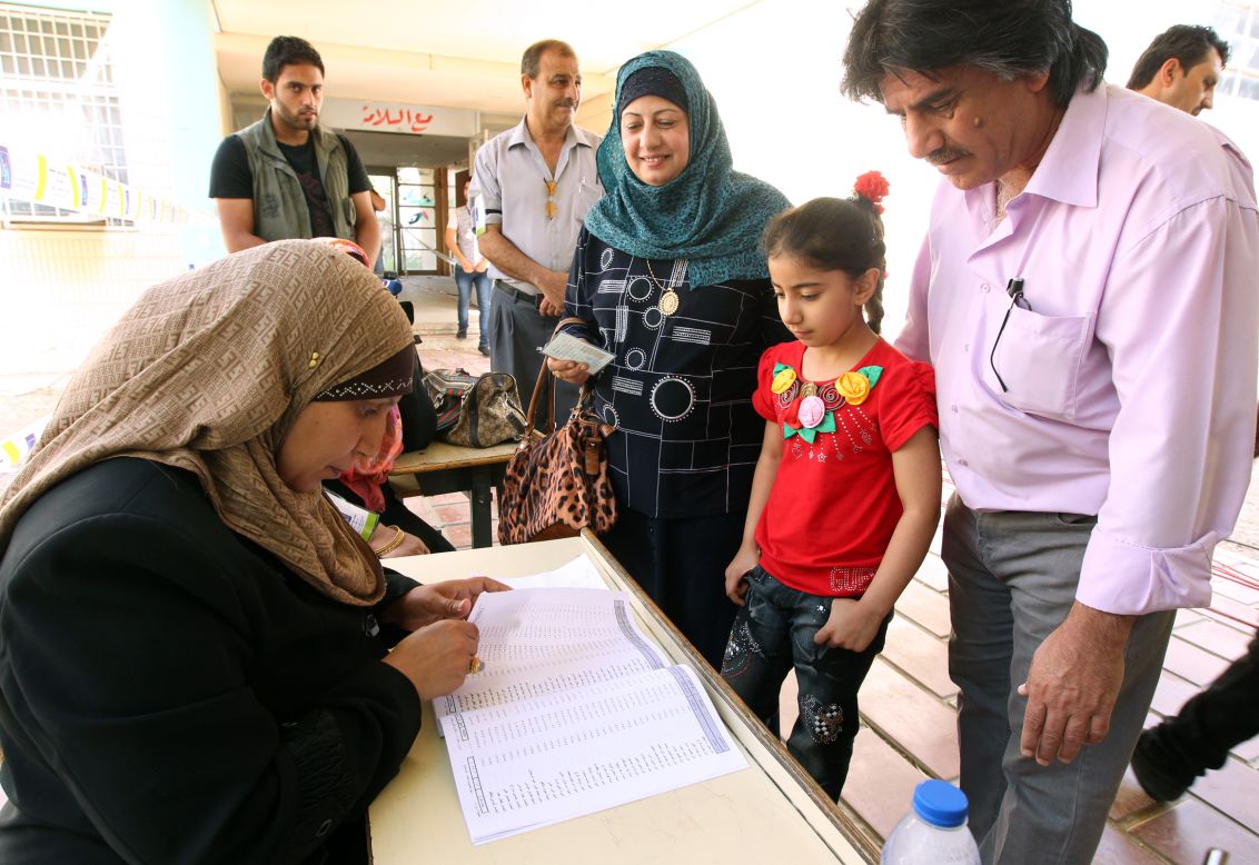 Iraqis cast their ballots at a polling station on Saturday in Baghdad.