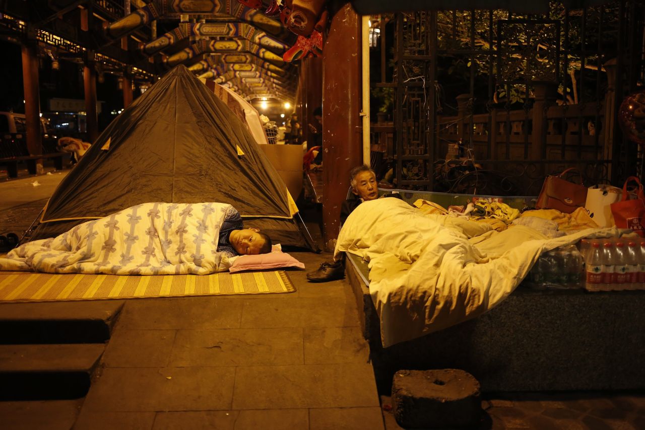 Chinese residents sleep in open areas for fear of aftershocks in Sichuan Province on Sunday.