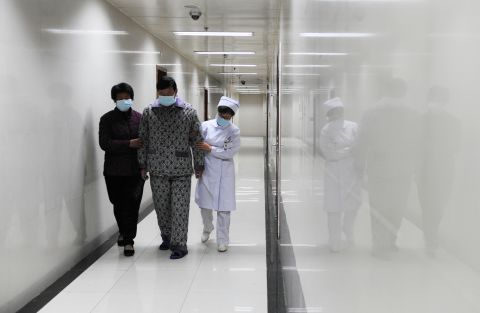 An H7N9 bird flu patient walks in the corridor of a hospital after his recovery and approval for discharge in Bozhou, in central China's Anhui Province, on Friday, April 19. 
