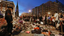 BOSTON, MA - APRIL 20: People gather at a makeshift memorial for victims near the site of the Boston Marathon bombings a day after the second suspect was captured on April 20, 2013 in Boston, Massachusetts. 