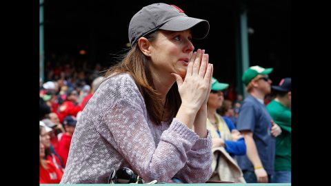 A woman sheds a tear during pregame ceremonies Saturday.