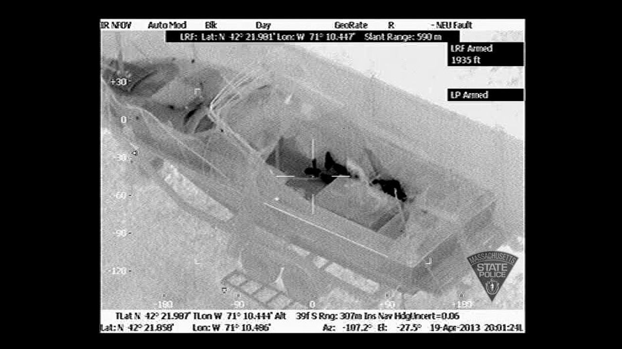 The heat signature clearly shows the suspect's feet and the rest of his body behind the boat console at 8:01 p.m., minutes before he surrendered.