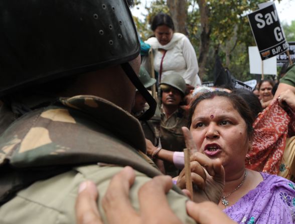  argue with Indian police outside the residence of Sonia Gandhi, chairwoman of the United Progressive Alliance, in New Delhi on Sunday, April 21, at a demonstration against the alleged rape of a 5-year-old girl. 