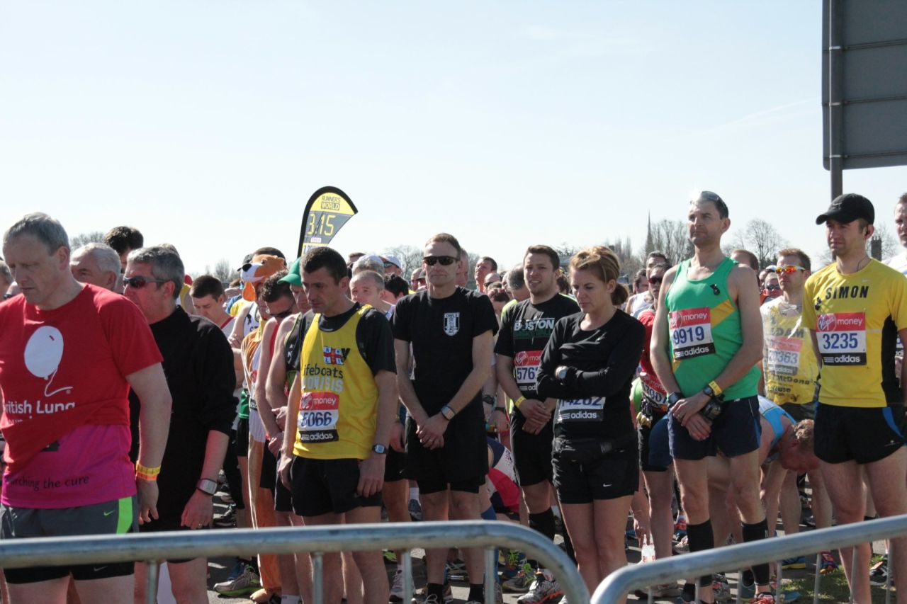 Athletes bow their heads at the start in Blackheath Common while observing the 30-second silence to remember those killed and injured by the blasts near the finish of the Boston Marathon on Monday.