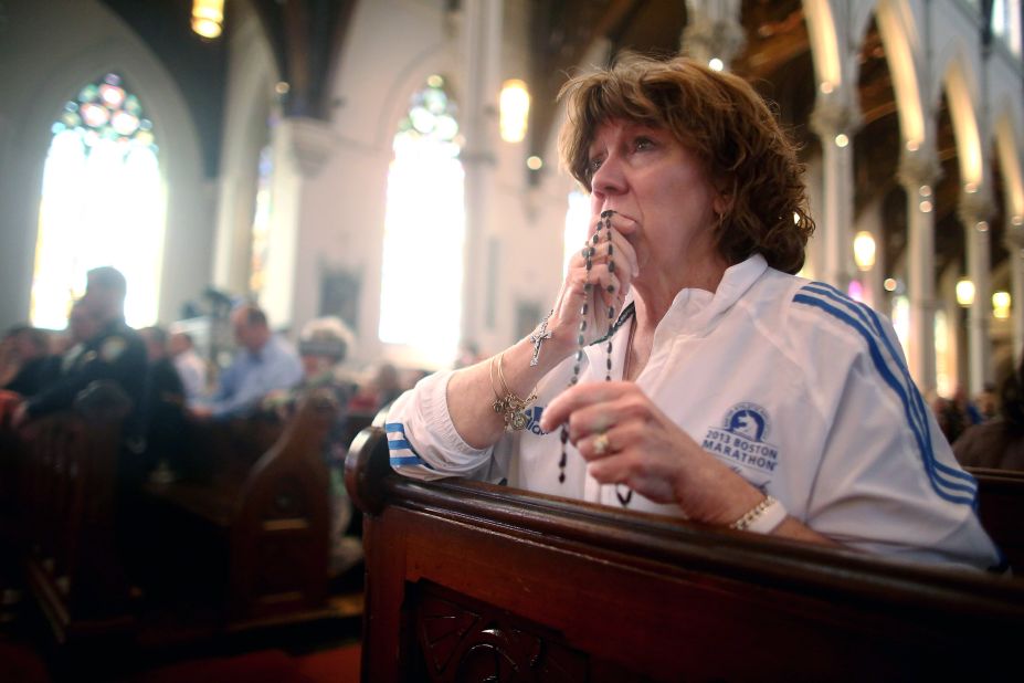 Nurse practitioner Maureen Quaranto, who treated victims of the bombings, wears her Boston Marathon jacket during Mass on April 21, 2013.