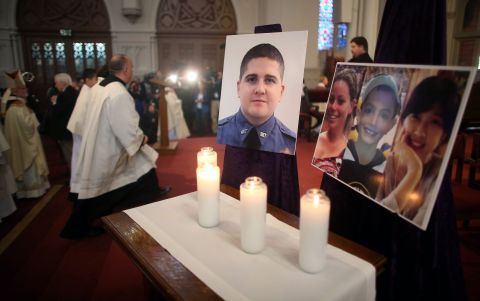 Photos of the deceased are displayed in Boston at the Cathedral of the Holy Cross on April 21, 2013.