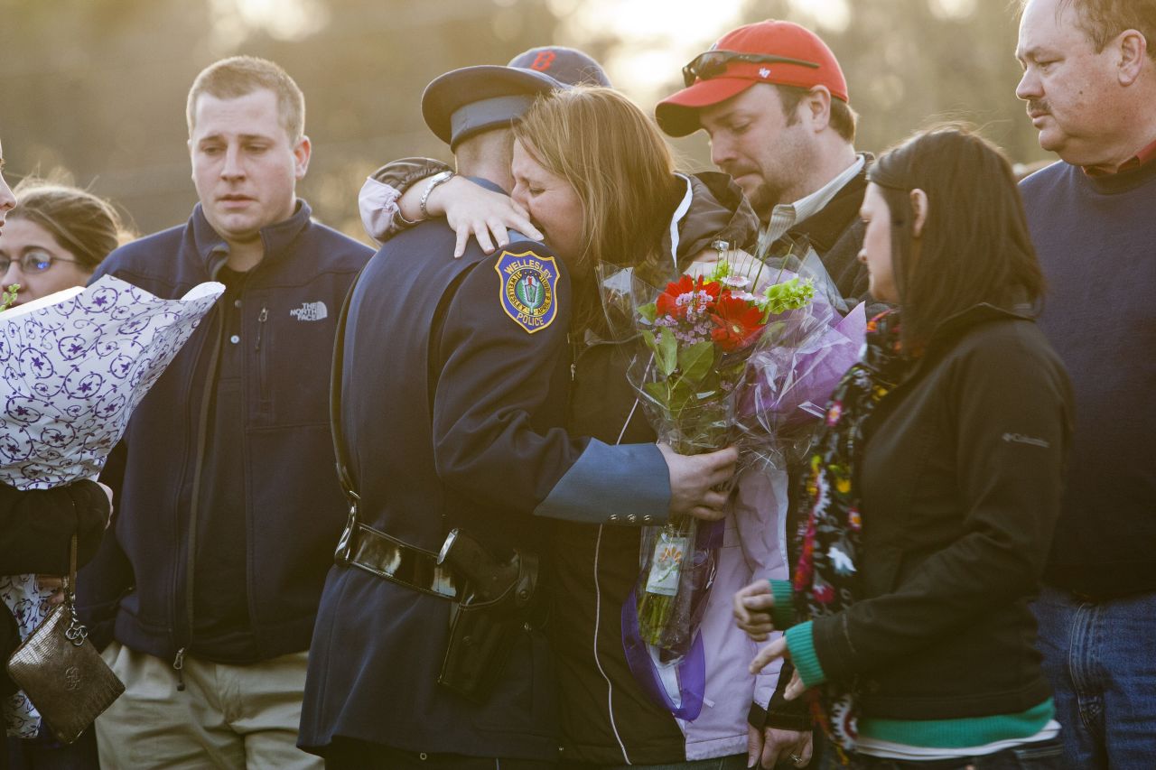 Nicole Collier Lynch, Collier's sister, hugs a police officer during a vigil in Wilmington, Massachusetts, on April 20, 2013.