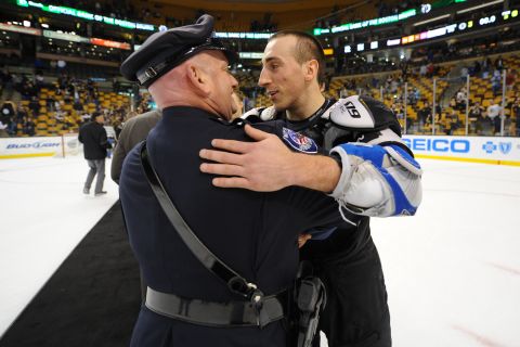 Brad Marchand of the Boston Bruins embraces one of the first responders from the Boston Marathon attack after the game against the Florida Panthers at the TD Garden on Sunday, April 21, in Boston. 