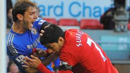Liverpool striker Luis Suarez (R) clashes with Branislav Ivanovic after appearing to bite the Chelsea player in the second half of Sunday's 2-2 draw.
