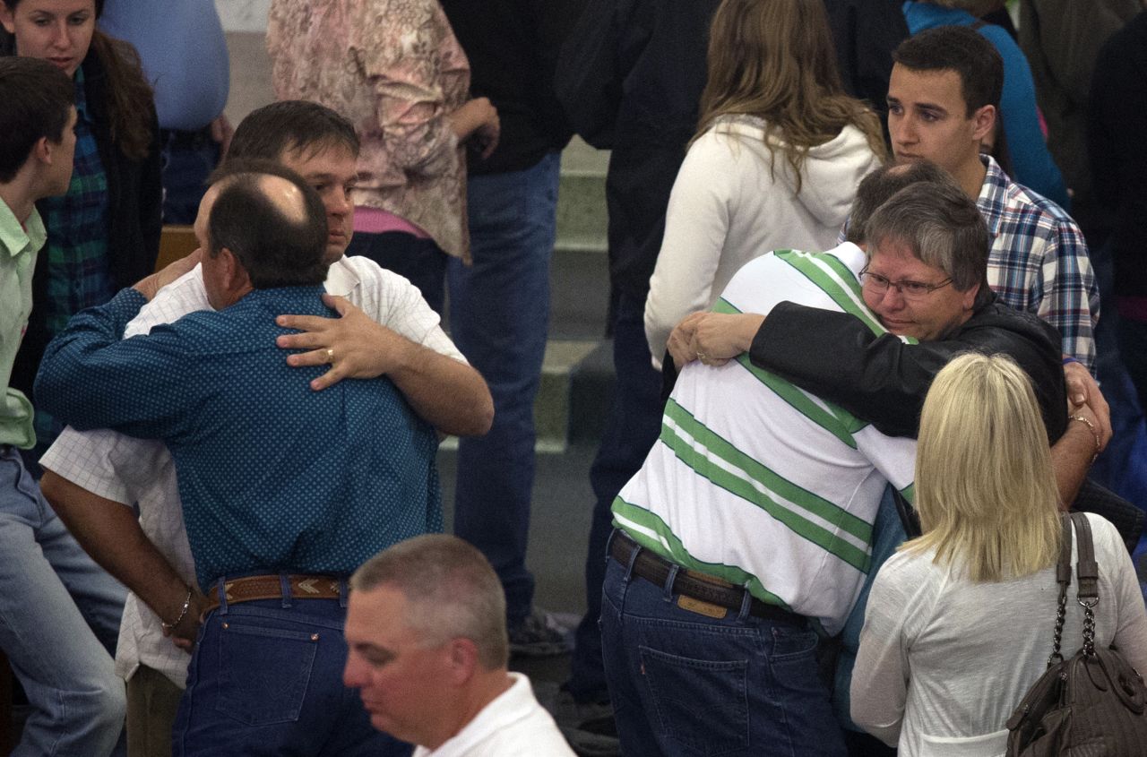 Residents embrace after a Sunday service at St. Mary's Catholic Church on April 21, four days after the deadly explosion.