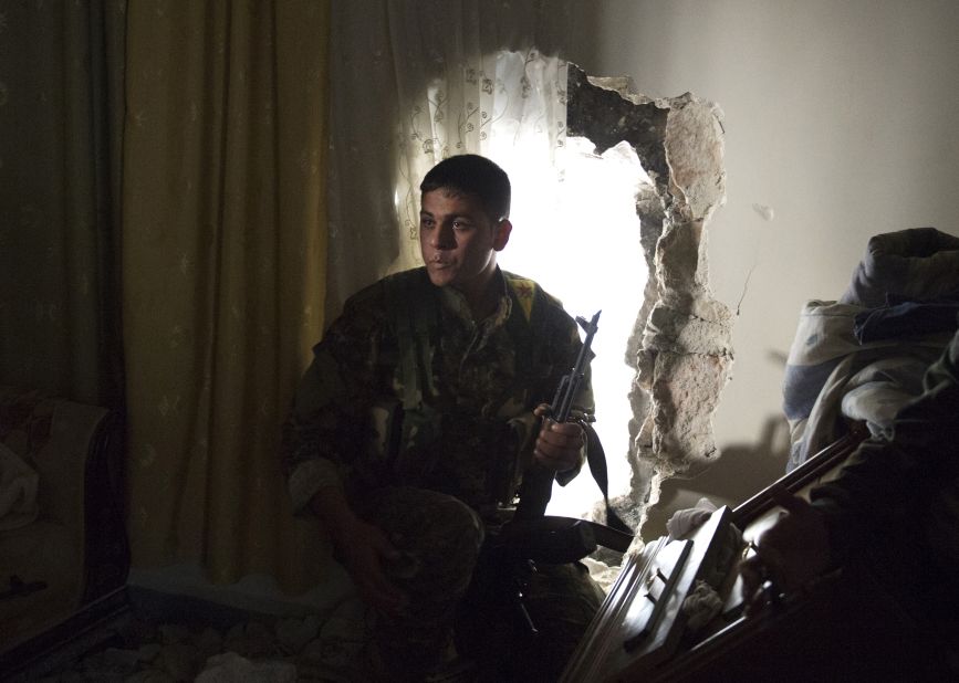 A Kurdish fighter from the "Popular Protection Units" (YPG) takes position inside a building in the majority-Kurdish Sheikh Maqsood area of Aleppo, on Apri. 21.