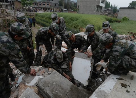 Chinese soldiers search for survivors on Sunday, April 21, in Lushan County.