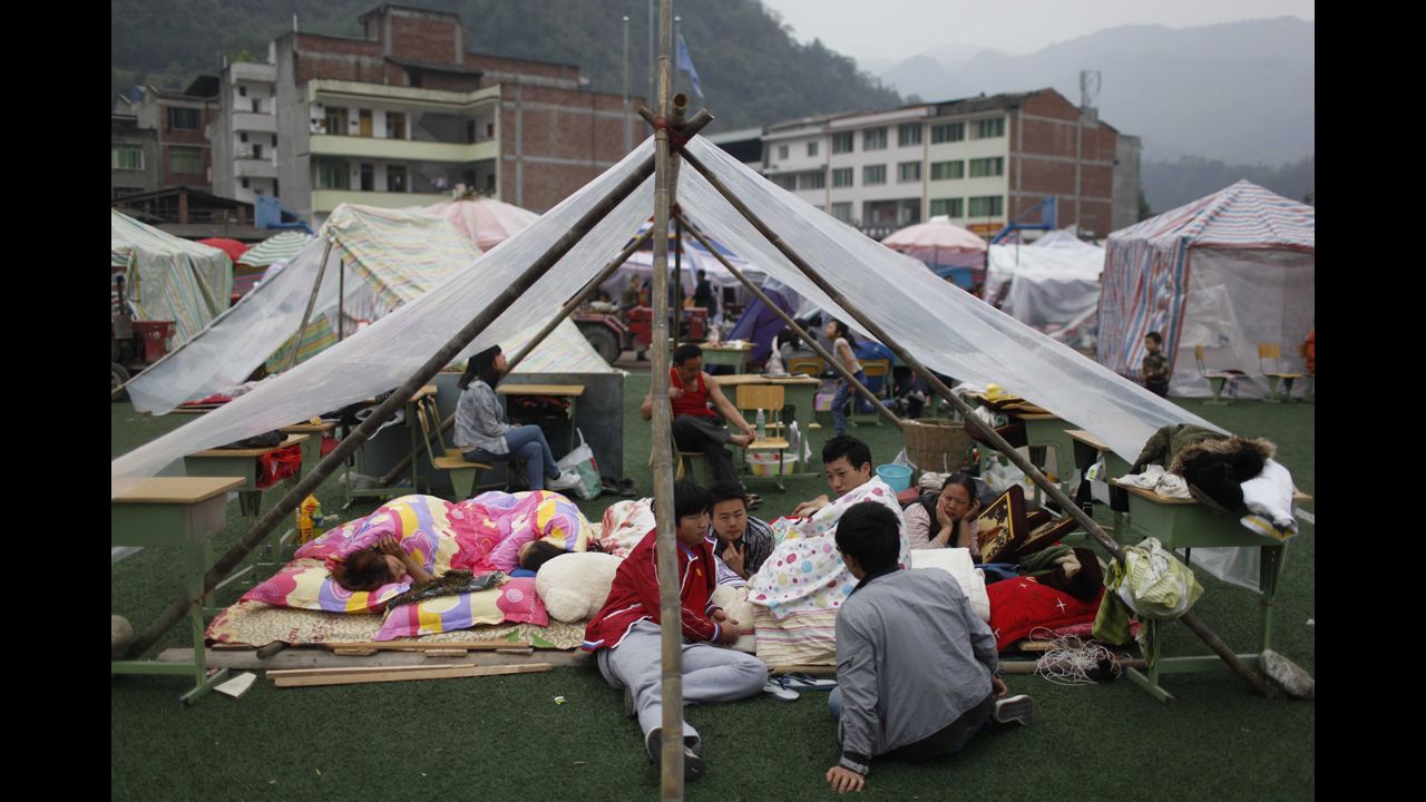Families rest at an emergency relief center in Ya'an on Sunday.