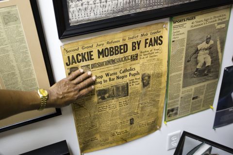 Hadley points out a front-page story in black-owned Pittsburgh Courier about Jackie Robinson, who became a Brooklyn Dodger in 1947.