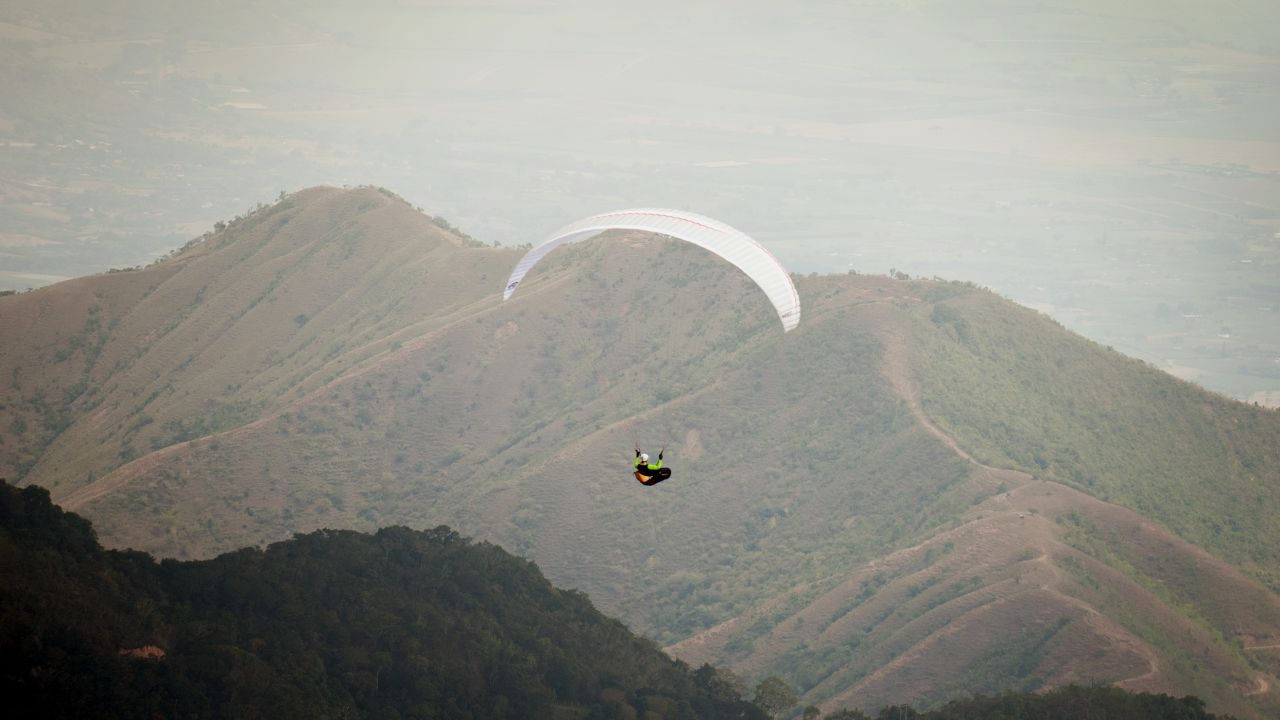 Austrian paraglider pilot Othmar Dickbauer flies above the mountains in Roldanillo, Valle del Cauca department, Colombia, during the Paragliding World Cup Superfinal, January 2013. 