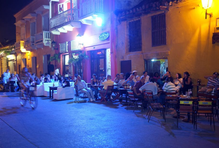 People sit outside restaurants and bars situated on the corner of a small square inside the city walls in January 2012 in Cartagena.