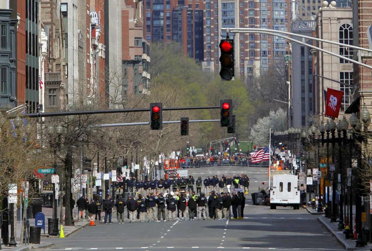 Officials line Boylston Street as they observe a moment of silence near the marathon finish line on April 22, 2013.